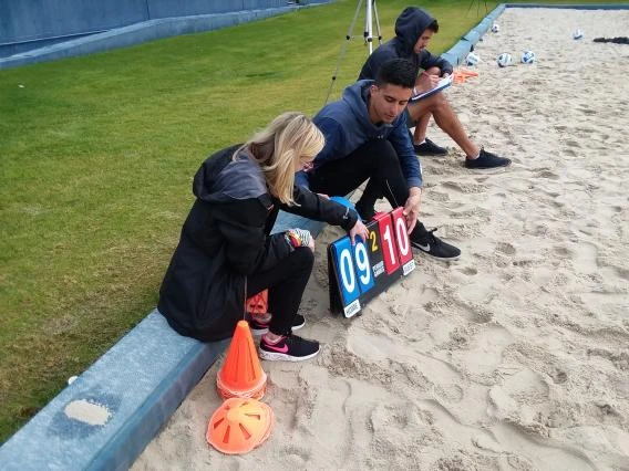 3 students keeping the score of a game