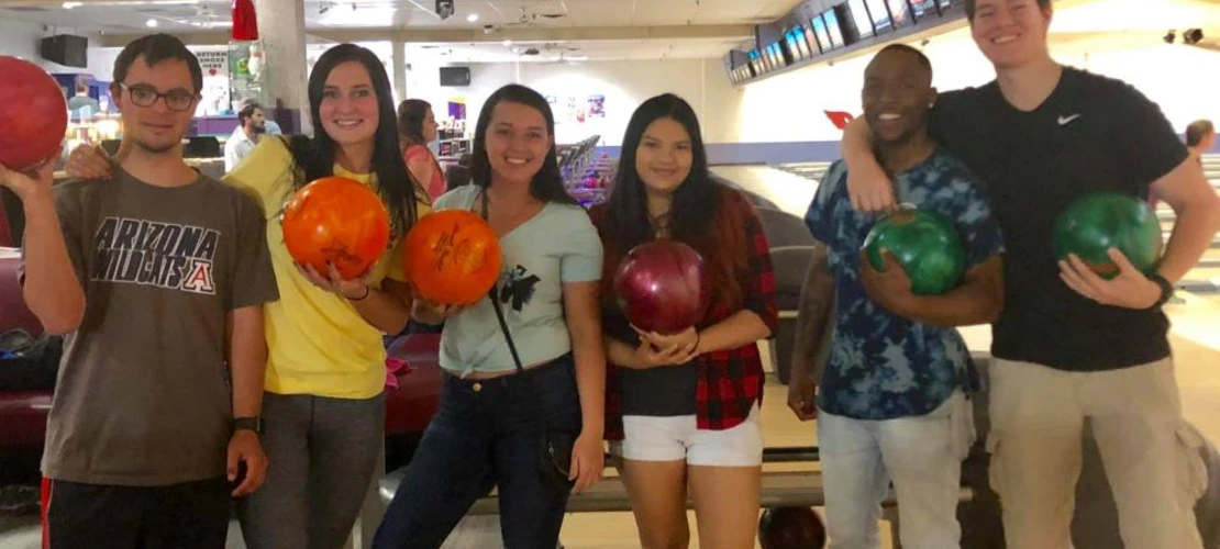 group of students posing in bowling alley