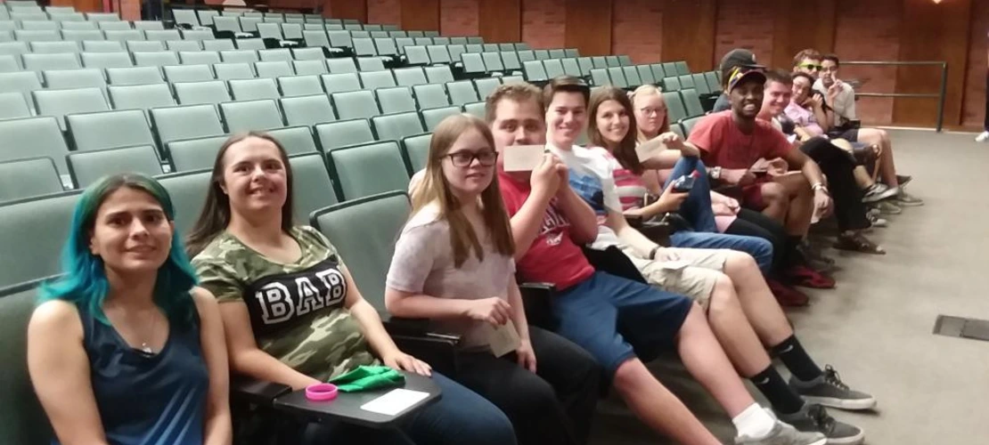 group of students seated in auditorium for graduation practice