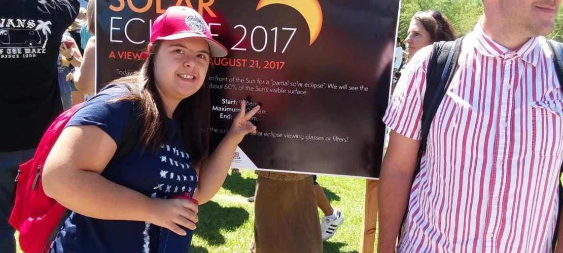 female student and male peer mentor attending 2017 solar eclipse event on campus mall